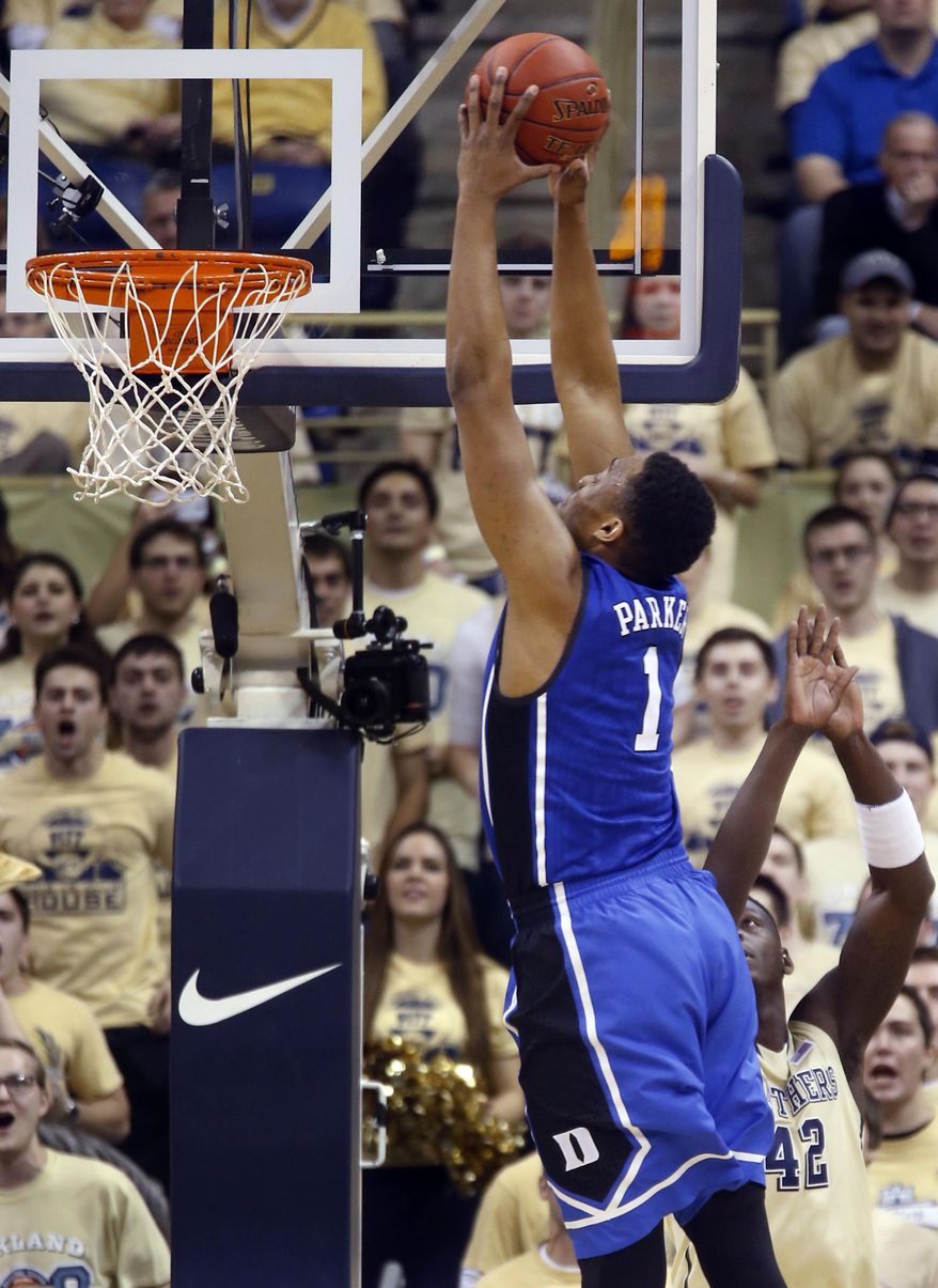 Duke's Jabari Parker (1) goes over Pittsburgh's Talib Zanna (42) for a dunk during the first half of an NCAA college basketball game on Monday, Jan. 27, 2014, in Pittsburgh. (AP Photo/Keith Srakocic)