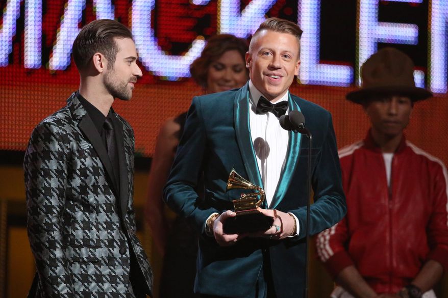 Ryan Lewis, left, and Macklemore accept the award for best new artist at the 56th annual Grammy Awards at Staples Center on Sunday, Jan. 26, 2014, in Los Angeles. (Photo by Matt Sayles/Invision/AP)