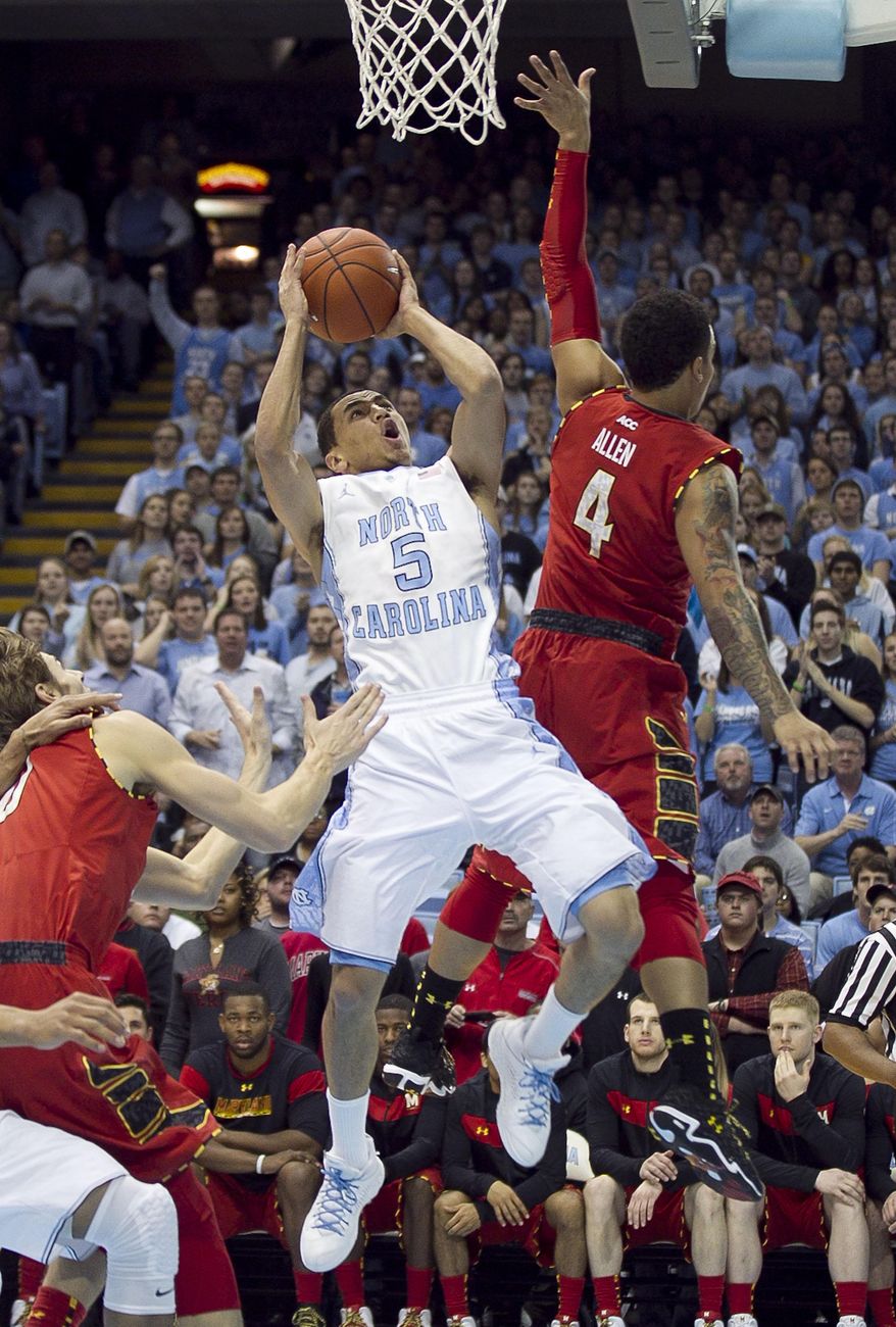 North Carolina's Marcus Paige (5) drives to the basket against Maryland's Seth Allen (4) during the first half of an NCAA basketball game, Tuesday, Feb. 4, 2014 at the Smith Center in Chapel Hill, N.C. (AP Photo/The News & Observer, Robert Willett)