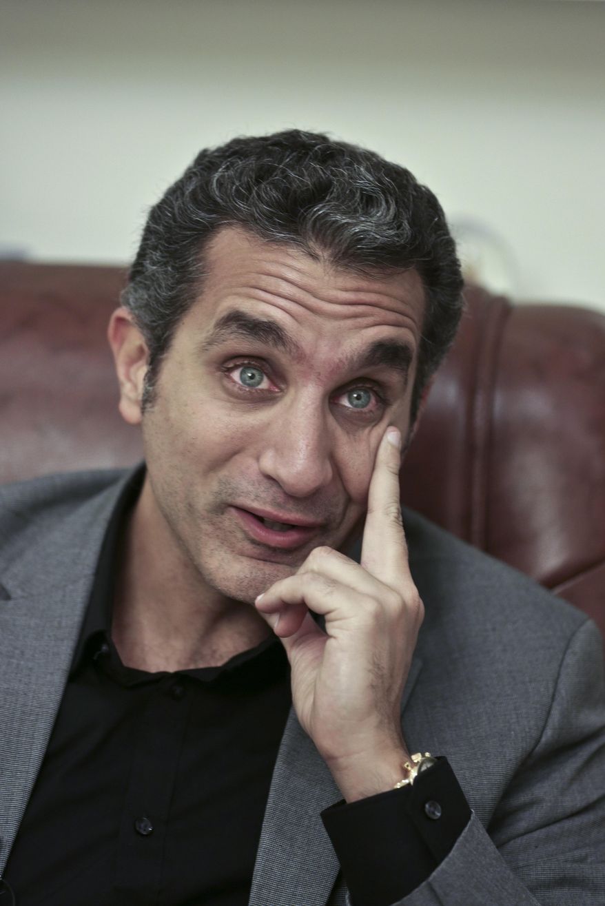 FILE - In this file photo taken Wednesday, Jan. 8, 2014, Egyptian satirist Bassem Youssef speaks during an interview with The Associated Press in Cairo, Egypt. Youssef was back on air on Friday, Feb. 7, true to his style of mocking the euphoria gripping Egyptians surrounding the country's military chief Abdel-Fattah el-Sissi, who is widely expected to run for president. Private broadcaster CBC had suspended Youssef's show last fall after the season's first episode, but he returned on a different broadcaster. (AP Photo/Nariman El-Mofty, File)