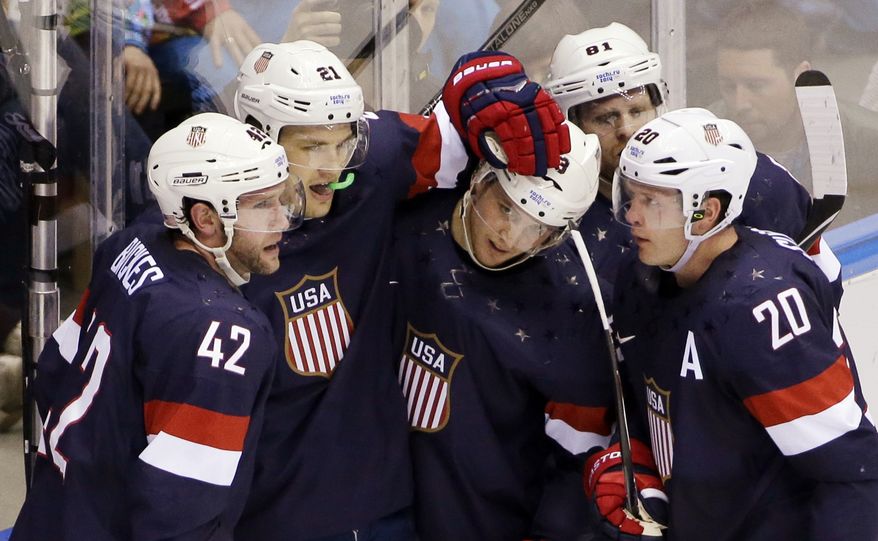 Team USA celebrates a second period goal against Russia during a men's ice hockey game at the 2014 Winter Olympics, Saturday, Feb. 15, 2014, in Sochi, Russia. (AP Photo/David J. Phillip )