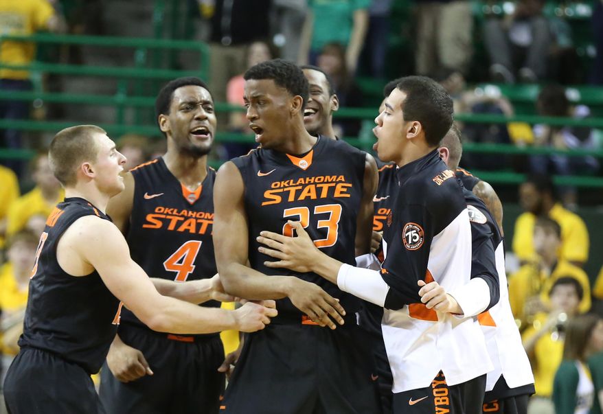 Oklahoma State players grab forward Leyton Hammonds (23) after sending their game against Baylor to overtime in an NCAA college basketball game, Monday, Feb. 17, 2014, in Waco, Texas. Baylor won 70-64. (AP Photo/Waco Tribune Herald, Rod Aydelotte)