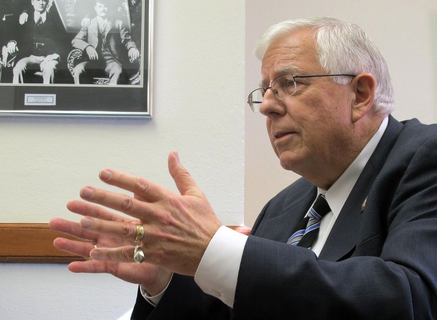 ** FILE ** Sen. Mike Enzi, R-Wyo., addresses reporters Wednesday, Feb. 19, 2014, at the Wyoming Capitol. (AP Photo/Ben Neary)