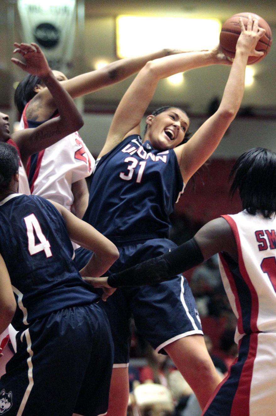 CORRECTS TO AN NCAA GAME Connecticut center Stefanie Dolson (31) brings down a rebound during the first half of an NCCA women's basketball game against Houston, Saturday, Feb. 22, 2014, in Houston. (AP Photo/Patric Schneider)