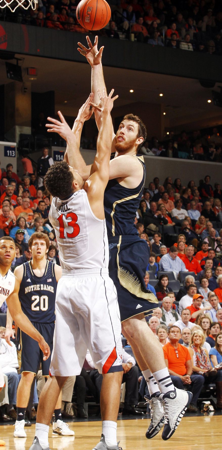 Notre Dame center Garrick Sherman, right, shoots over Anthony Gill during an NCAA college basketball game Saturday, Feb. 22, 2014, in Charlottesville, Va. (AP Photo/Andrew Shurtleff)