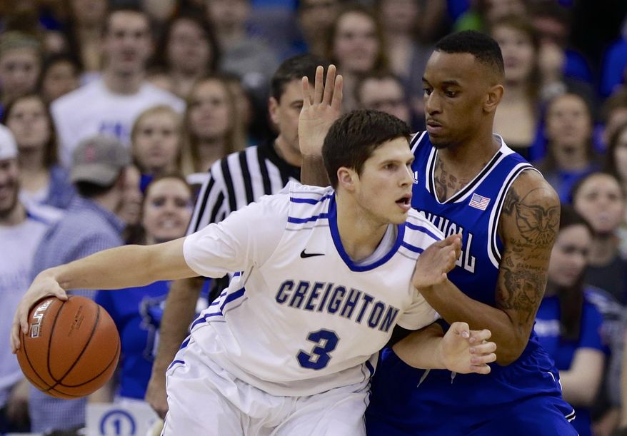 Creighton's Doug McDermott (3) drives around Seton Hall's Brandon Mobley (2) in the first half of an NCAA college basketball game in Omaha, Neb., Sunday, Feb. 23, 2014. (AP Photo/Nati Harnik)