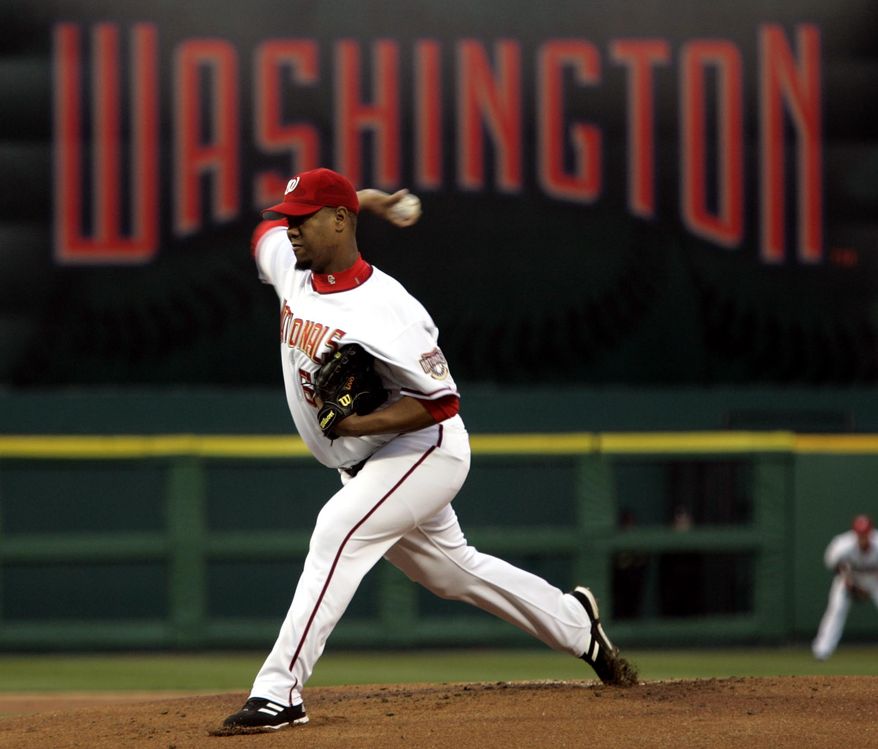 Washington Nationals pitcher Livan Hernandez throws the first pitch of the game against the Arizona Diamondbacks in the Washington Nationals home opener Thursday, April 14, 2005, in Washington. (AP Photo/Evan Vucci)