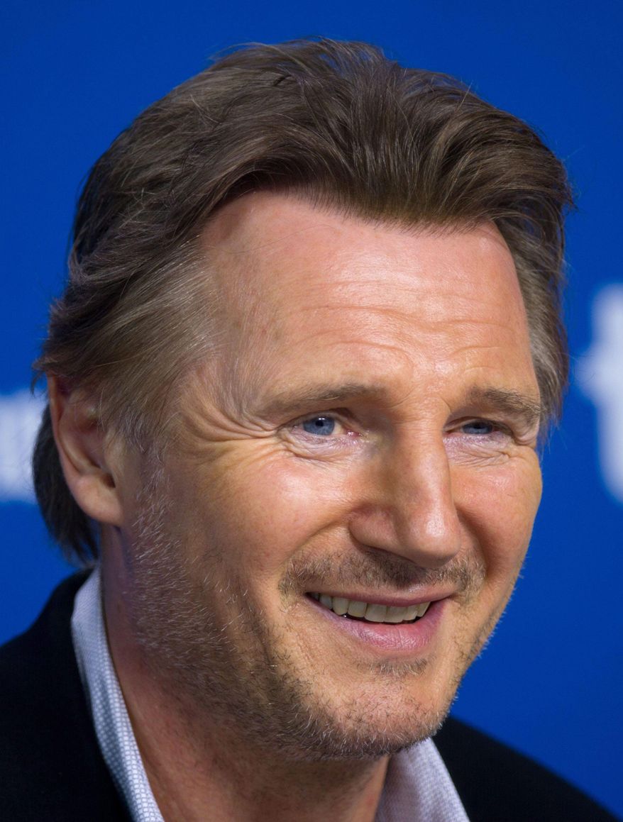 File-This Sept. 10, 2013 file photo shows actor Liam Neeson smiling during a press conference for "Third Person" at the 2013 Toronto International Film Festival in Toronto. Neeson says he's "a little bit pissed off" at Mayor Bill de Blasio for wanting to shut down the horse-drawn carriage industry in New York City. Neeson made the comment during an appearance on "The Daily Show" Wednesday, Feb. 26, 2014. The actor complained to host John Stewart that critics have put out false information about how the horses are treated. He says the carriage drivers treat the horses like their own children. (AP Photo/The Canadian Press, Galit Rodan, File)