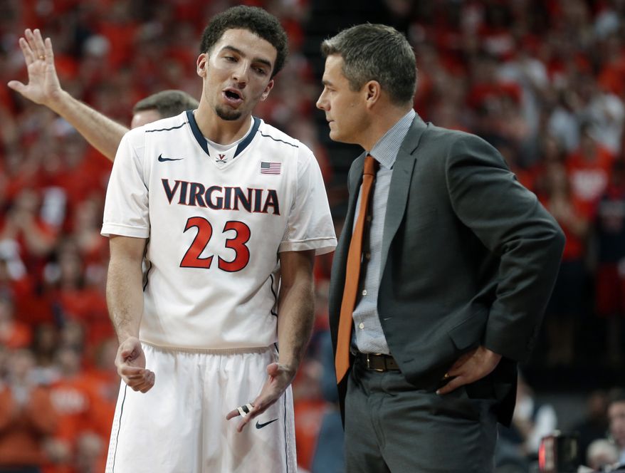 Virginia guard London Perrantes (23) talks with head coach Tony Bennett during the second half of an NCAA College basketball game in Charlottesville, Va., Saturday, March 1, 2014. Virginia won the game 75-56. (AP Photo/Steve Helber)