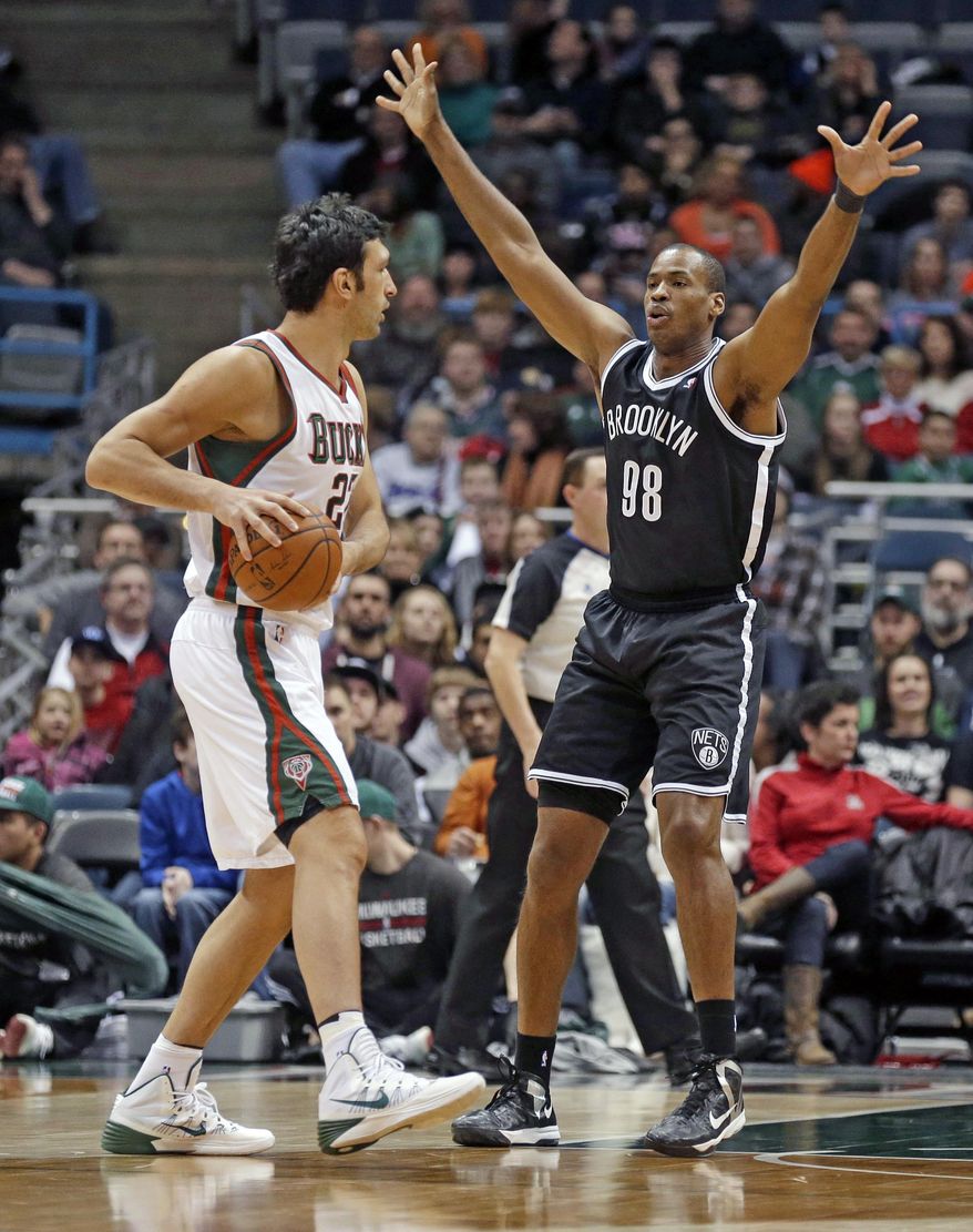 Brooklyn Nets' Jason Collins (98) defends against Milwaukee Bucks' ZaZa Pachulia, left, in the first half of an NBA basketball game, Saturday, March 1, 2014, in Milwaukee. (AP Photo/Jeffrey Phelps)