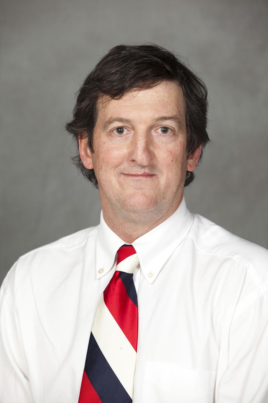 This photo taken Feb. 24, 2014, and provided by the Arkansas Secretary of State on Thursday, March 6, 2014, shows Circuit Judge Mike Maggio posing in Little Rock, Ark. Maggio has admitted that he anonymously posted online comments that critics say are racist, sexist and otherwise inappropriate, including one in which he revealed alleged details of confidential adoption proceedings involving actress Charlize Theron and her son. (AP Photo/Arkansas Secretary of State, Danny Harris)