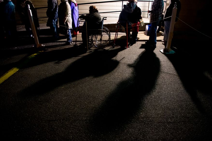Donna Gilfilen of Fairfield, Va., center, who has a variety of medical issues including a bad hip, waits in line in a wheelchair in the cold pre-dawn hours to be let into the Remote Area Medical's facilities to be seen by a doctor at Southern Virginia University, Buena Vista, Va., Saturday, March 1, 2014. Remote Area Medical Volunteer Corps (RAM) is a Knoxville, Tennessee-based, non-profit, volunteer, airborne medical relief corps that provides free health care, dental care, eye care, veterinary services, and technical and educational assistance to people in remote areas of the United States, and around the world for people that need it. (Andrew Harnik/The Washington Times)