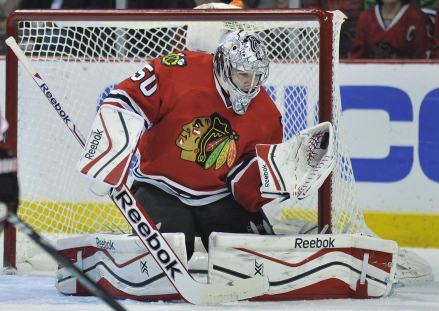 Chicago Blackhawks goalie Corey Crawford makes a save during the first period of an NHL hockey game against the St. Louis Blues in Chicago, Wednesday, March, 19, 2014. (AP Photo/Paul Beaty)