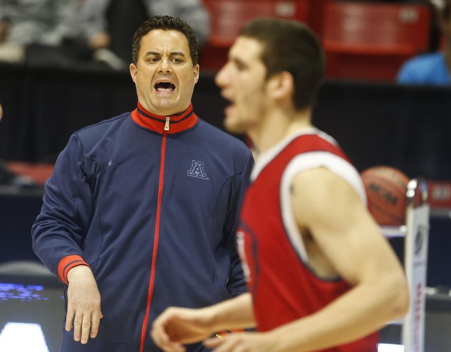 Arizona coach Sean Miller, left, shouts instructions during practice for an NCAA college basketball tournament game on Thursday, March 20, 2014, in San Diego. Arizona faces Weber State in a second-round game on Friday. (AP Photo/Lenny Ignelzi)