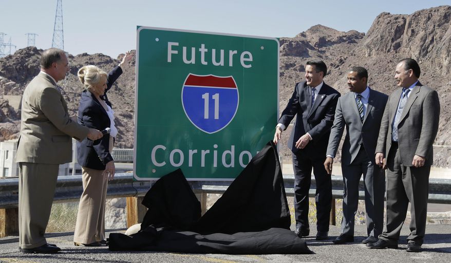 From left, Arizona Department of Transportation director John Halikowski, Arizona governor Jan Brewer, Nevada governor Brian Sandoval, Steven Horsford, D-Nev., and Nevada Department of Transportation director Rudy Malfabon unveil a sign that will mark the corridor for the future Interstate 11 between Phoenix and Las Vegas, Friday, March 21, 2014, at Hoover Dam, Ariz. It was a symbolic effort meant to keep up momentum on the project, which is coming of age in an era of scarce highway funding. (AP Photo/Julie Jacobson)