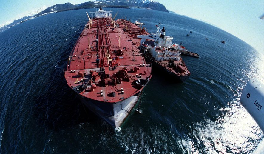 In this April 4, 1989, file photo, the grounded tanker Exxon Valdez, left, unloads oil onto a smaller tanker, San Francisco, as efforts to re-float the ship continue on Prince William Sound, 25 miles from Valdez, Alaska. The 987-foot tanker, carrying 53 million gallons of crude, struck Bligh Reef at 12:04 a.m. on March 24, 1989, and within hours unleashed an estimated 10.8 million gallons of thick, toxic crude oil into the water. Storms and currents then smeared it over 1,300 miles of shoreline. Twenty five years later, the region, its people and its wildfire are still recovering. (AP Photo, File) **FILE**
