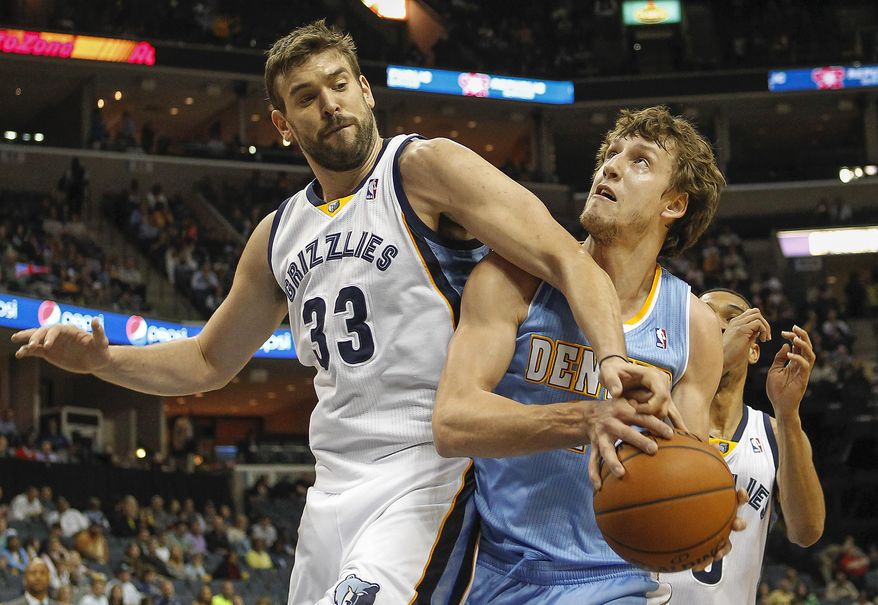 Memphis Grizzlies center Marc Gasol (33), of Spain, blocks a shot by Denver Nuggets forward Jan Vesely, of the Czech Republic, in the first half of an NBA basketball game Friday, April 4, 2014, in Memphis, Tenn. (AP Photo/Lance Murphey)