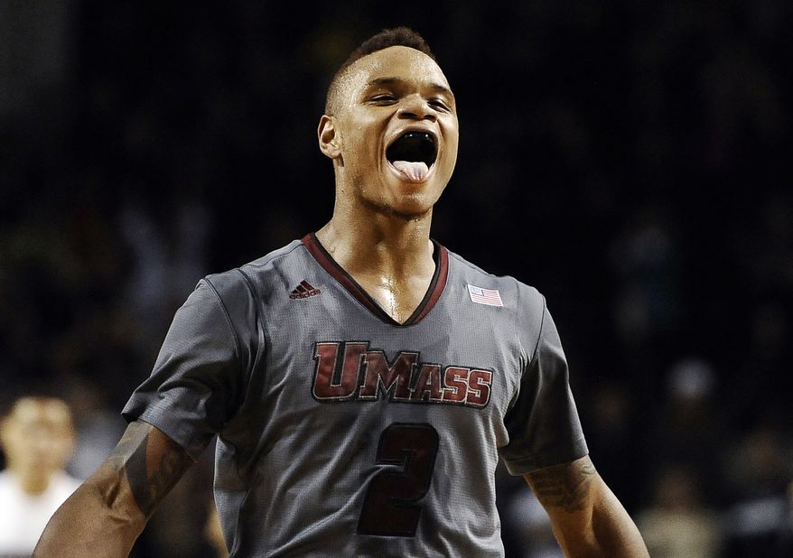 In this Dec. 28, 2013 file photo, UMass guard Derrick Gordon celebrates after hitting the go-ahead basket with one second left on the clock during overtime of an NCAA college basketball game against Providence, in Amherst, Mass. Gordon says in a televised interview that he is gay. Gordon made the announcement on ESPN on Wednesday, April 9, 2014, becoming the first openly gay player in Division I men's basketball. (AP Photo/Jessica Hill, File)