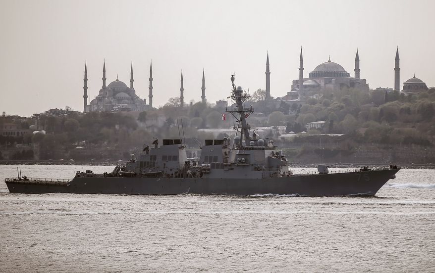 US warship, the USS Donald Cook, sails through the Bosporus in Istanbul, Turkey, Thursday, April 10, 2014, en route to the Black Sea. According to a US Department of Defense press release, the guided missile destroyer's deployment is part of " the U.S. commitment to mutual goals in the region," and that it will participate in operations and exercises in the area. Istanbul's two landmarks Haghia Sophia, right, and Blue Mosque are in the background.(AP Photo/Emrah Gurel)