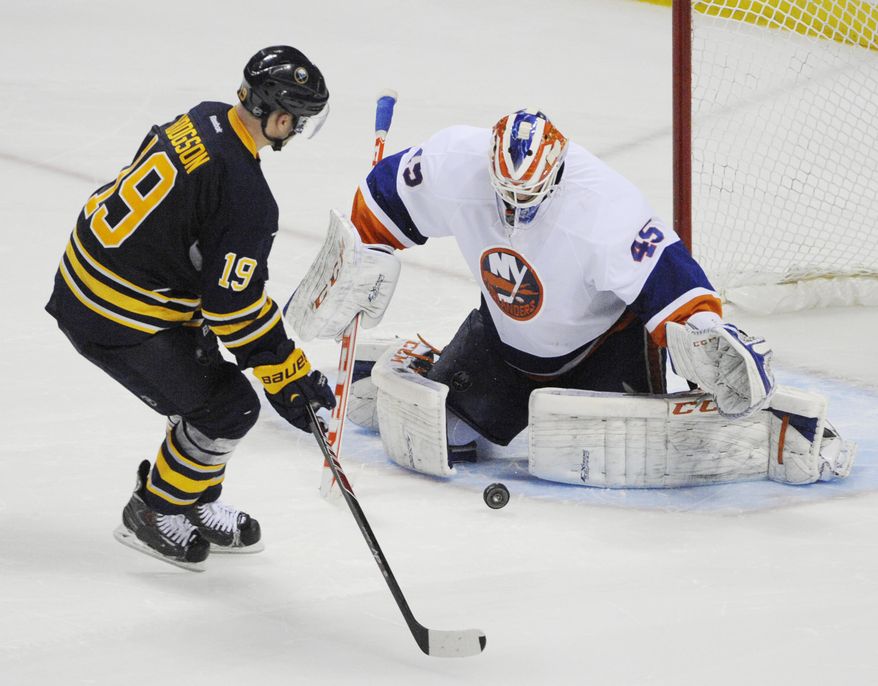 The shot by Buffalo Sabres' Cody Hodgson (19) gets stopped by New York Islanders' Anders Nilsson (45), of Sweden, during the team shootout during an NHL hockey game in Buffalo, N.Y., Sunday April 13, 2014. New York won 4-3. (AP Photo/Gary Wiepert)