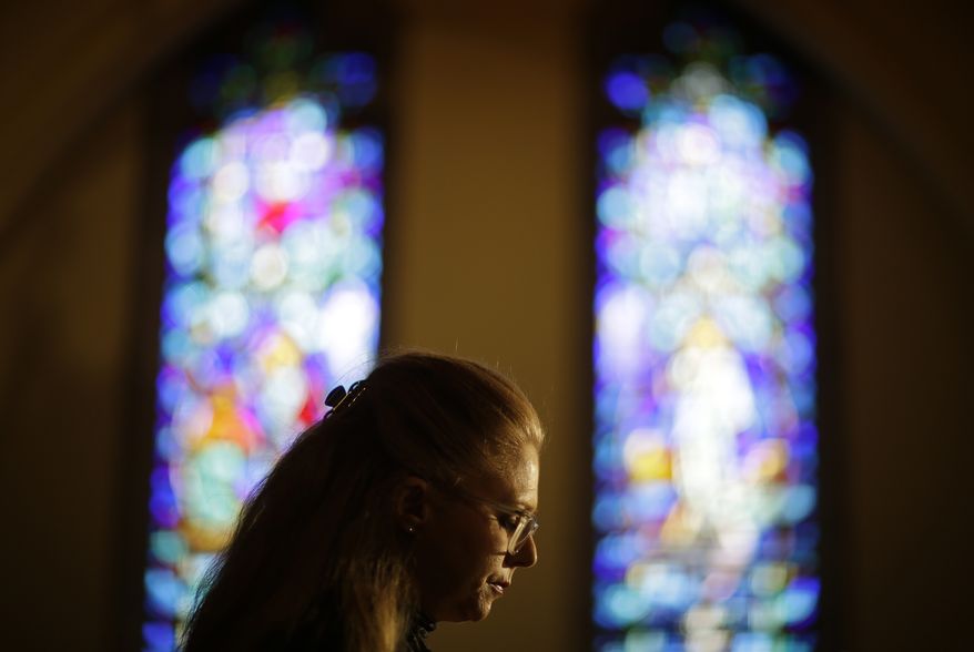 Kathryn Grant, with The Campaign to Keep Guns Off Campus, speaks during a rally protesting a gun bill the governor is signing today expanding where people with licenses to carry can bring their guns in Georgia, at Central Presbyterian Church, Wednesday, April 23, 2014, in Atlanta. The bill makes several changes to state law. It allows those with a license to carry to bring a gun into a bar without restriction and into some government buildings that don't have certain security measures. It also allows religious leaders to decide whether it's OK for a person with a carry license to bring a gun into their place of worship. And school districts would now be able, if they want, to allow some employees to carry a firearm under certain conditions. (AP Photo/David Goldman)