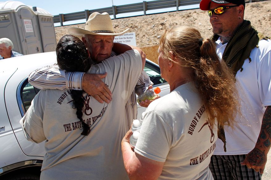 Rancher Cliven Bundy hugs a supporter before holding a press conference near Bunkerville, Nev. Thursday, during which Mr. Bundy denied Thursday that he was a racist. (Associated Press)