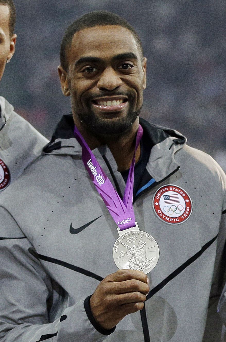 FILE - In this Aug. 11, 2012, file photo, Tyson Gay celebrates after receiving the silver medal for the men's 4x100-meter race during the athletics competition in the Olympic Stadium at the 2012 Summer Olympics, London. Gay has accepted a one-year suspension and has returned the silver medal he won at the London Olympics after he tested positive for a prohibited substance, USADA announced Friday, May 2, 2014. (AP Photo/Matt Slocum, File)