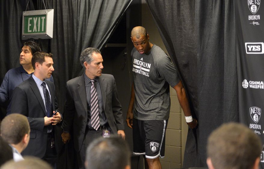 FILE - In this Feb. 23, 2014 file photo, Brooklyn Nets center Jason Collins enters a news conference prior to an NBA basketball game against the Los Angeles Lakers in Los Angeles after signing a 10-day contract with the Brooklyn Nets earlier in the day. Collins used an April 2013 column in Sports Illustrated to become the first openly gay player in the NBA. (AP Photo/Mark J. Terrill)