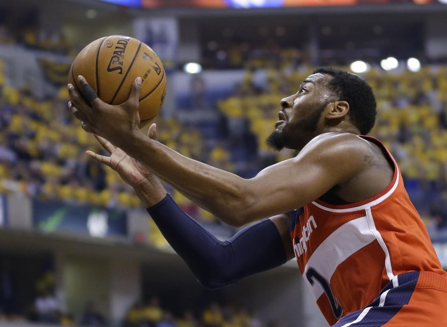 Washington Wizards' John Wall (2) puts up a shot during the first quarter of game 1 of the Eastern Conference semifinal NBA basketball playoff series against the Indiana Pacers in Indianapolis, Monday, May 5, 2014(AP Photo/Michael Conroy)