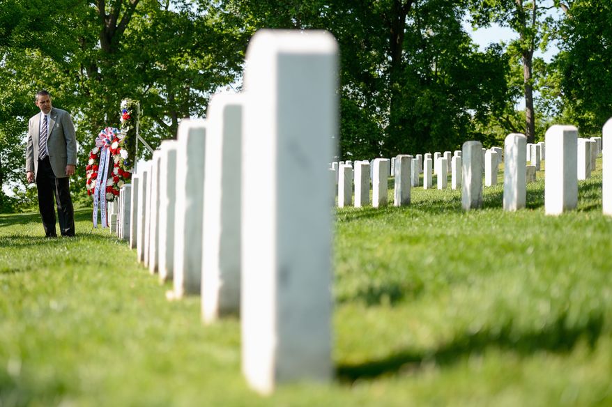 James Christman, great-grandnephew of Army Pvt. William Christman, stands at his grave stone. Christman was the first hero buried in Arlington National Cemetery. (andrew harnik/the washington times)