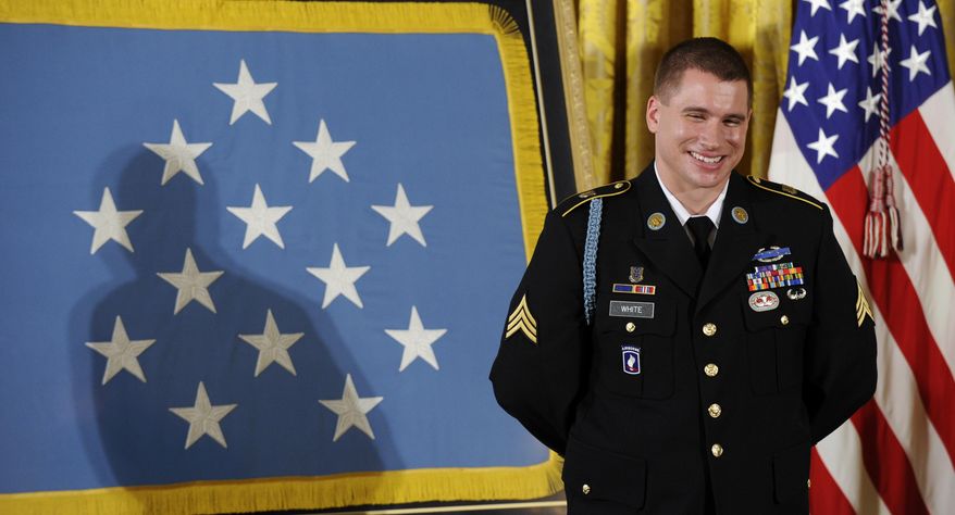 Former Army Sgt. Kyle J. White smiles as President Barack Obama talks about him before he was awarded the Medal of Honor during a ceremony in the East Room of the White House in Washington, Tuesday, May 13, 2014. White is a former Army sergeant who saved a fellow soldier's life and helped secure the evacuation of other wounded Americans while under persistent fire during a 2007 ambush in Afghanistan. White is the seventh living recipient to be awarded the Medal of Honor for actions in Iraq or Afghanistan. (AP Photo)