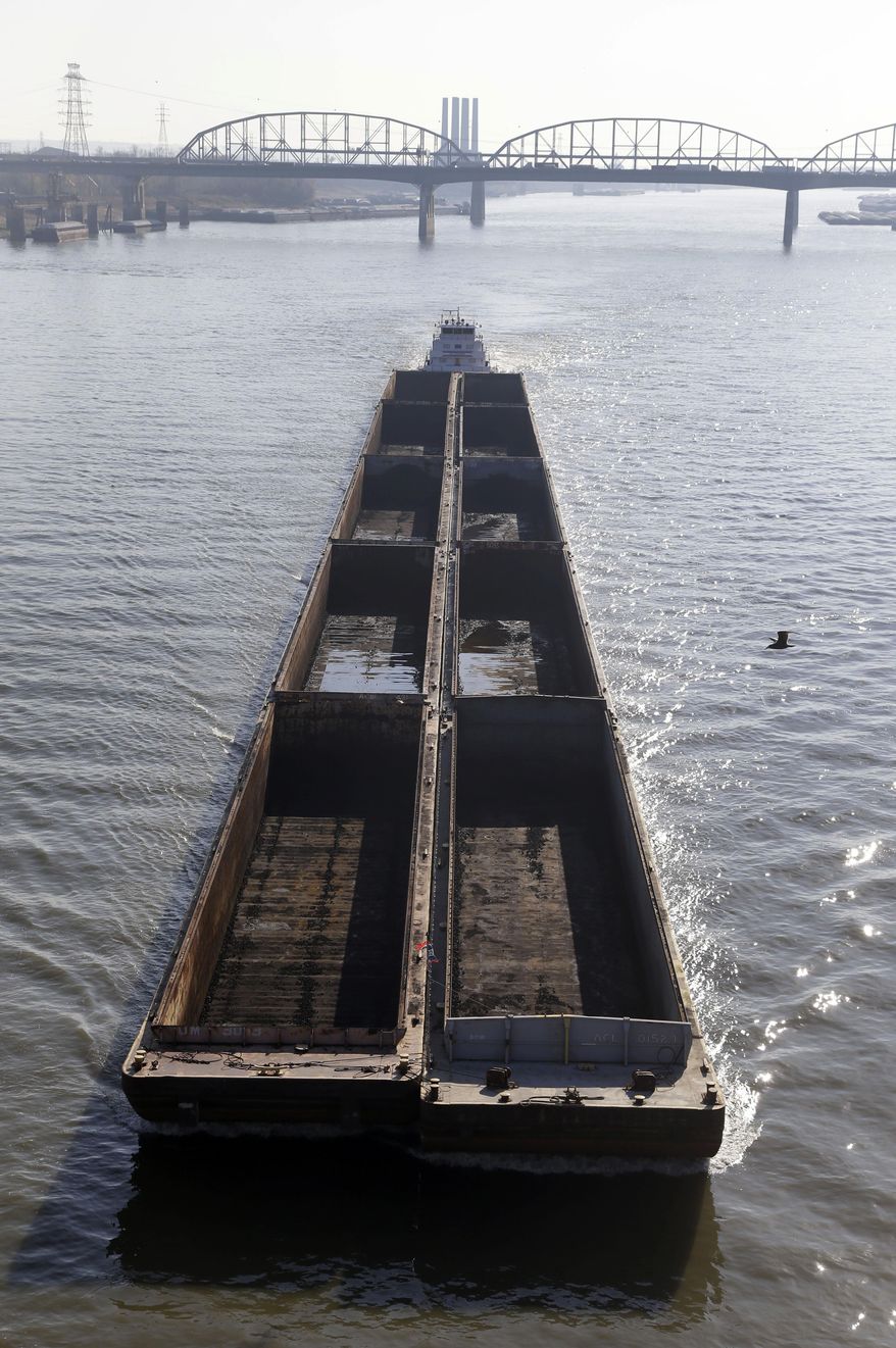 FILE - In this Nov. 16, 2012 file photo, a barge powers its way up the Mississippi River in St. Louis. Environmental groups have sued the Army Corps of Engineers over the agency's use of man-made structures meant to keep the Mississippi River navigable. The federal lawsuit was filed Thursday, May 22, 2014 in Illinois' East St. Louis. Plaintiffs including the National Wildlife Federation claim the techniques provoke flooding as seen during historic inundations four times in the past two decades. (AP Photo/Jeff Roberson, File)