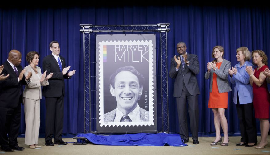 Deputy Postmaster General Ronald A. Stroman, fourth from right, and others, applaud during the unveiling ceremony of the Harvey Milk Forever Stamp in the South Court Auditorium of the Eisenhower Executive Office Building on the White House complex in Washingotn, Thursday, May 22, 2014. Joining Stroman, from left are, Rep. John Lewis, D-Ga., House Minority Leader Nancy Pelosi of Calif., Stuart Milk, Founder and President, Harvey Milk Foundation, Ambassador UN Ambassador Samantha Power, Sen. Tammy Baldwin, D-Wis., and Rep. Debbie Wasserman Schultz, D-Fla. On the day he would have turned 84 years old, Harvey Milk, the San Francisco supervisor and gay activist gunned down at City Hall in 1978, had a postal stamp in his honor unveiled at the White House today. (AP Photo/Pablo Martinez Monsivais)