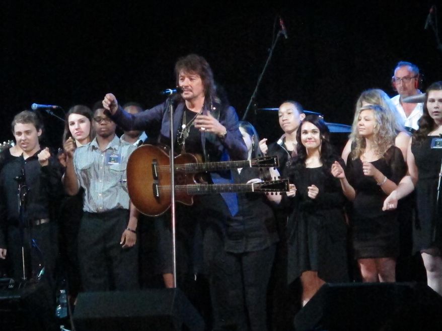 Bon Jovi guitarist Richie Sambora performs a new song, "Lighthouse" at an anti-drug forum in Toms River N.J. on May 27, 2014. The song will raise money for a drug treatment center in New Jersey.(AP Photo/Wayne Parry)