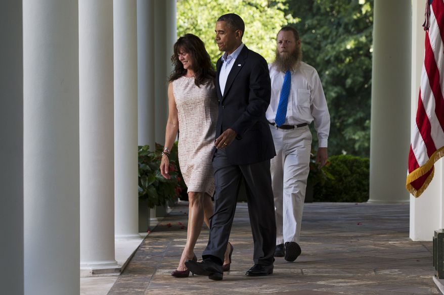 Jani Bergdahl, left, and Bob Bergdahl, walk with President Barack Obama for a news conference in the Rose Garden of the White House in Washington on Saturday, May 31, 2014 about the release of their son, U.S. Army Sgt. Bowe Bergdahl. Bergdahl, 28, had been held prisoner by the Taliban since June 30, 2009. He was handed over to U.S. special forces by the Taliban in exchange for the release of five Afghan detainees held by the United States. (AP Photo/Jacquelyn Martin)