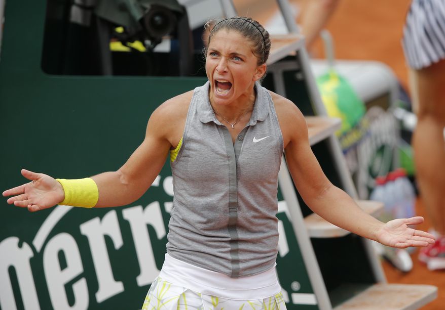 Italy's Sara Errani reacts after defeating Serbia's Jelena Jankovic during their fourth round match of the French Open tennis tournament at the Roland Garros stadium, in Paris, France, Monday, June 2, 2014. (AP Photo/David Vincent)