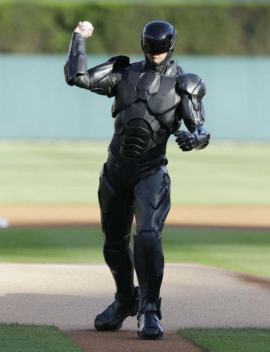 The movie character Robocop throws out a ceremonial first pitch before a baseball game between the Detroit Tigers and the Toronto Blue Jays in Detroit, Tuesday, June 3, 2014. (AP Photo/Carlos Osorio)