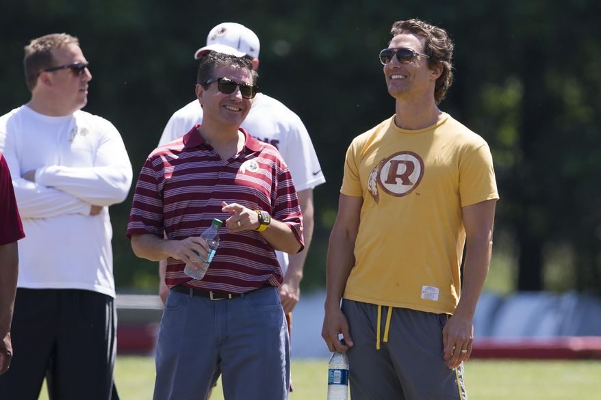 Actor Matthew McConaughey, right, stands with Washington Redskins owner Daniel Snyder during NFL football practice at Redskins Park, on Wednesday, June 4, 2014, in Ashburn, Va. (AP Photo/ Evan Vucci)