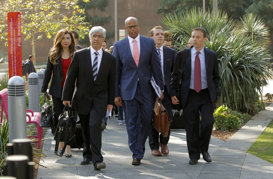 **FILE** Attorneys Theodore Boutrous (second from left) and Marcellus McRae (third from left), representing nine California public school students who are suing the state to abolish its laws on teacher tenure, seniority, and other protections, walk to a news conference outside the Los Angeles Superior Court on Jan. 27, 2014. Their case Vergara v. California is the latest battle in a growing nationwide challenge to union-backed protections for teachers. (Associated Press)