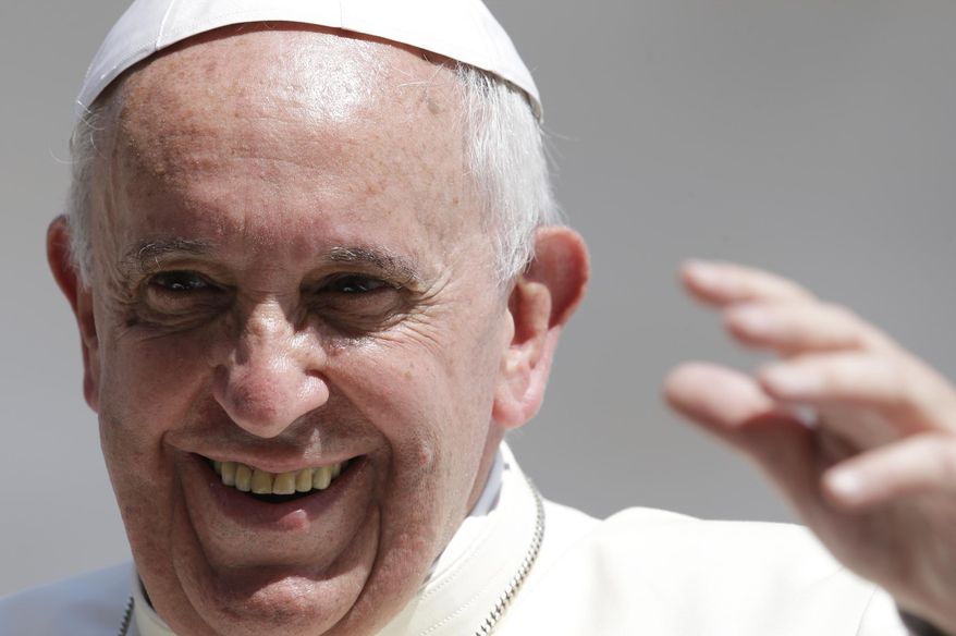 Pope Francis smiles as he waves to faithful at the end of his weekly general audience in St. Peter's Square at the Vatican, Wednesday, June 11, 2014. (AP Photo/Gregorio Borgia)