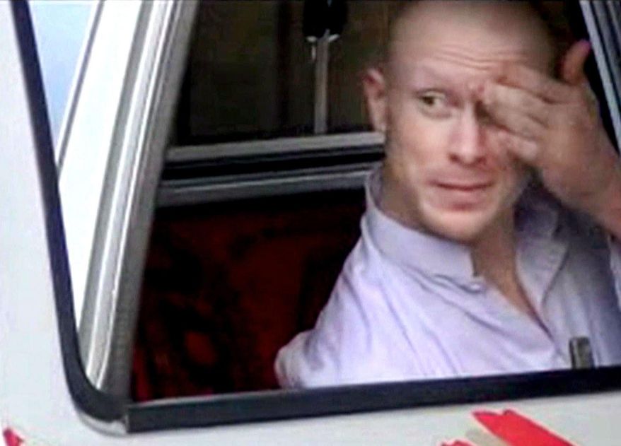 In this image taken from video obtained from Voice Of Jihad Website, which has been authenticated based on its contents and other AP reporting, Sgt. Bowe Bergdahl, sits in a vehicle guarded by the Taliban in eastern Afghanistan. A U.S. defense official says released captive Army Sgt. Bowe Bergdahl is scheduled to arrive at a military medical center in Texas on Friday. The official, who spoke Thursday on condition of anonymity because the plan has not been publicly announced, declined to provide details. Officials had previously said the intention was for Bergdahl to be reunited with his family at Brooke Army Medical Center in San Antonio. (AP Photo/Voice Of Jihad Website via AP video)