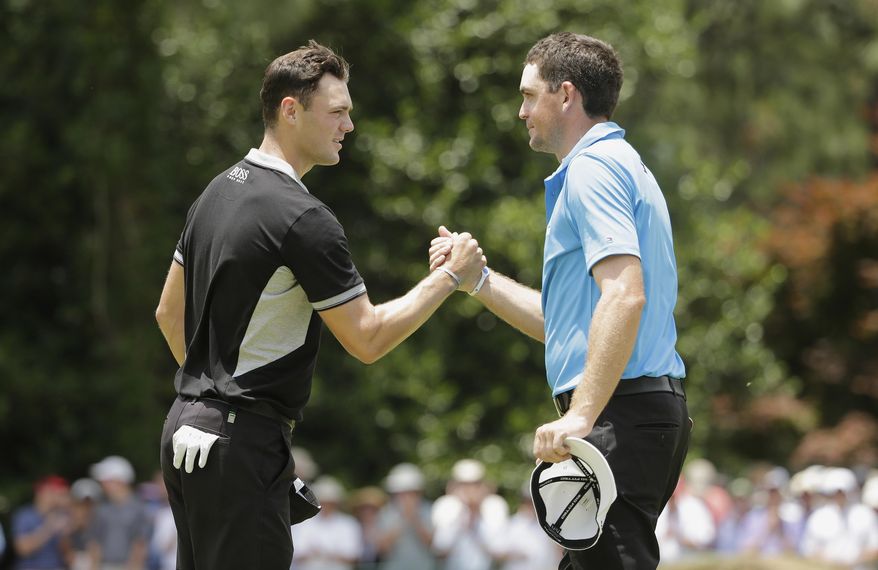 Martin Kaymer, of Germany, left, shakes hands with Keegan Bradley after the second round of the U.S. Open golf tournament in Pinehurst, N.C., Friday, June 13, 2014. (AP Photo/Chuck Burton)