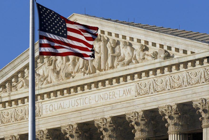 ** FILE ** This June 27, 2012, file photo shows an American flag in front of the U.S. Supreme Court in Washington. (AP Photo/Alex Brandon, File)