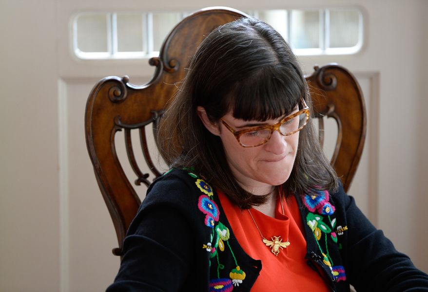 Kate Kelly, founder of Ordain Women, checks messages of support and requests for interviews, near the Church of Jesus Christ of Latter-day Saints in Salt Lake City on Monday, June 23, 2014, after getting an official message through email that she had been excommunicated, Monday, June 23, 2014. The excommunication is a rare move that brings down the harshest punishment available on an adherent, who created an organization and staged demonstrations in a push for women to join the faith's priesthood. (AP Photo/The Salt Lake Tribune, Francisco Kjolseth)