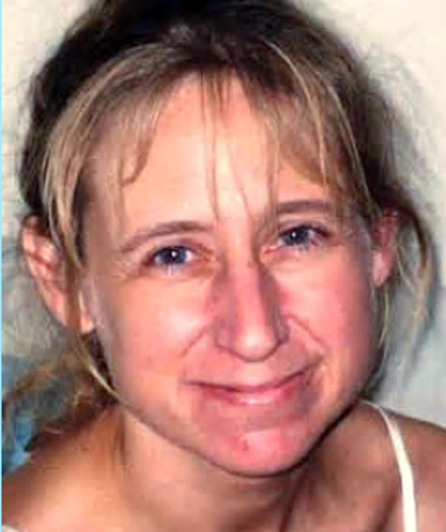 In this photo provided by the Town of Geneva, Wis., Police Department is Laura Simonson, 37, from Farmington, Minn. Authorities said Wednesday, June. 25, 2014 that a man was arrested in connection with the killing of Simonson, one of two women whose bodies were discovered June 5 in two suitcases discarded along a rural road in Town of Geneva. Authorities have not identified the remains of the second female. (AP Photo/Town of Geneva Police Department)