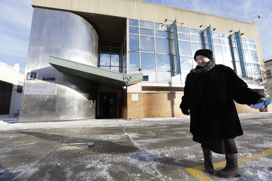 FILE -This Dec. 17, 2013 file photo shows anti-abortion protester Eleanor McCullen, of Boston, standing at the painted edge of a buffer zone outside a Planned Parenthood location in Boston. The Supreme Court has struck down a 35-foot protest-free zone outside abortion clinics in Massachusetts. The justices were unanimous Thursday that extending a buffer zone 35 feet from clinic entrances violates the First Amendment rights of protesters. (AP Photo/Steven Senne)