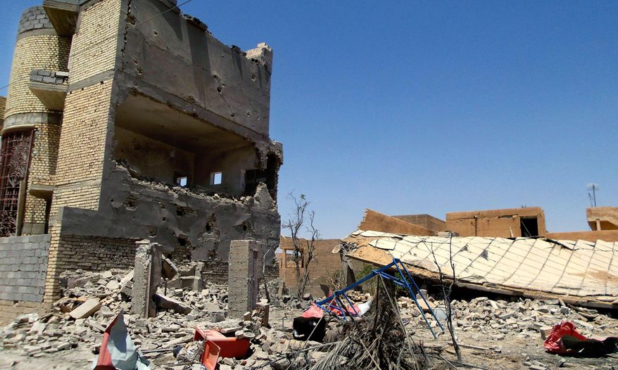 This photo taken on Tuesday, July 1, 2014, shows damaged homes due to clashes between fighters of the al-Qaida-inspired Islamic State of Iraq and the Levant (ISIL) and Iraqi security forces in Tikrit, 80 miles (130 kilometers) north of Baghdad, Iraq. The Islamic State of Iraq and the Levant announced this week that it has unilaterally established a caliphate in the areas under its control. It declared the group's leader, Abu Bakr al-Baghdadi, the head of its new self-styled state governed by Shariah law and demanded that all Muslims pledge allegiance to him. (AP Photo)