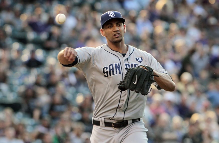San Diego Padres starting pitcher Tyson Ross (38) throws to first base to put out Colorado Rockies' Justin Morneau in the first inning of a baseball game in Denver on Tuesday, July 8, 2014. (AP Photo/Joe Mahoney)
