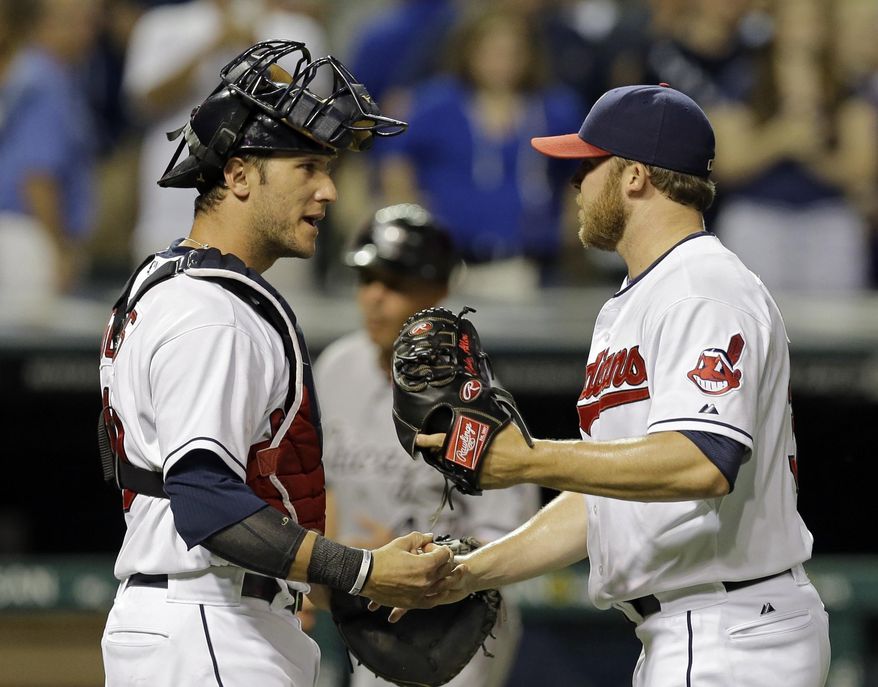 Cleveland Indians catcher Yan Gomes, left, congratulates relief pitcher Cody Allen after the final out in a 7-4 win over the Chicago White Sox in a baseball game Friday, July 11, 2014, in Cleveland. (AP Photo/Mark Duncan)