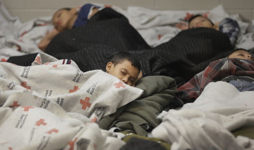 FILE - This June 18, 2014, file photo, detainees sleep in a holding cell at a U.S. Customs and Border Protection, processing facility in Brownsville,Texas. Immigration courts backlogged by years of staffing shortages and tougher enforcement face an even more daunting challenge since tens of thousands of Central Americans began arriving on the U.S. border fleeing violence back home. For years, children from Central America traveling alone and immigrants who prove they have a credible fear of returning home have been entitled to a hearing before an immigration judge. (AP Photo/Eric Gay, Pool, File)